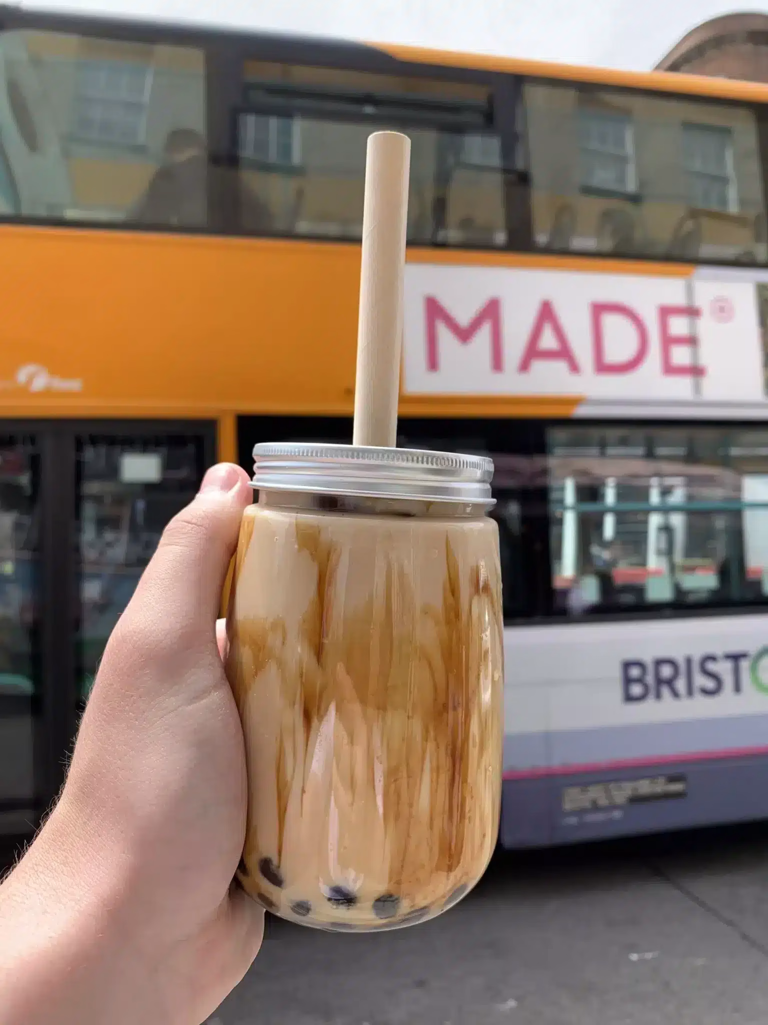 Holding a traditional bubble tea in the air