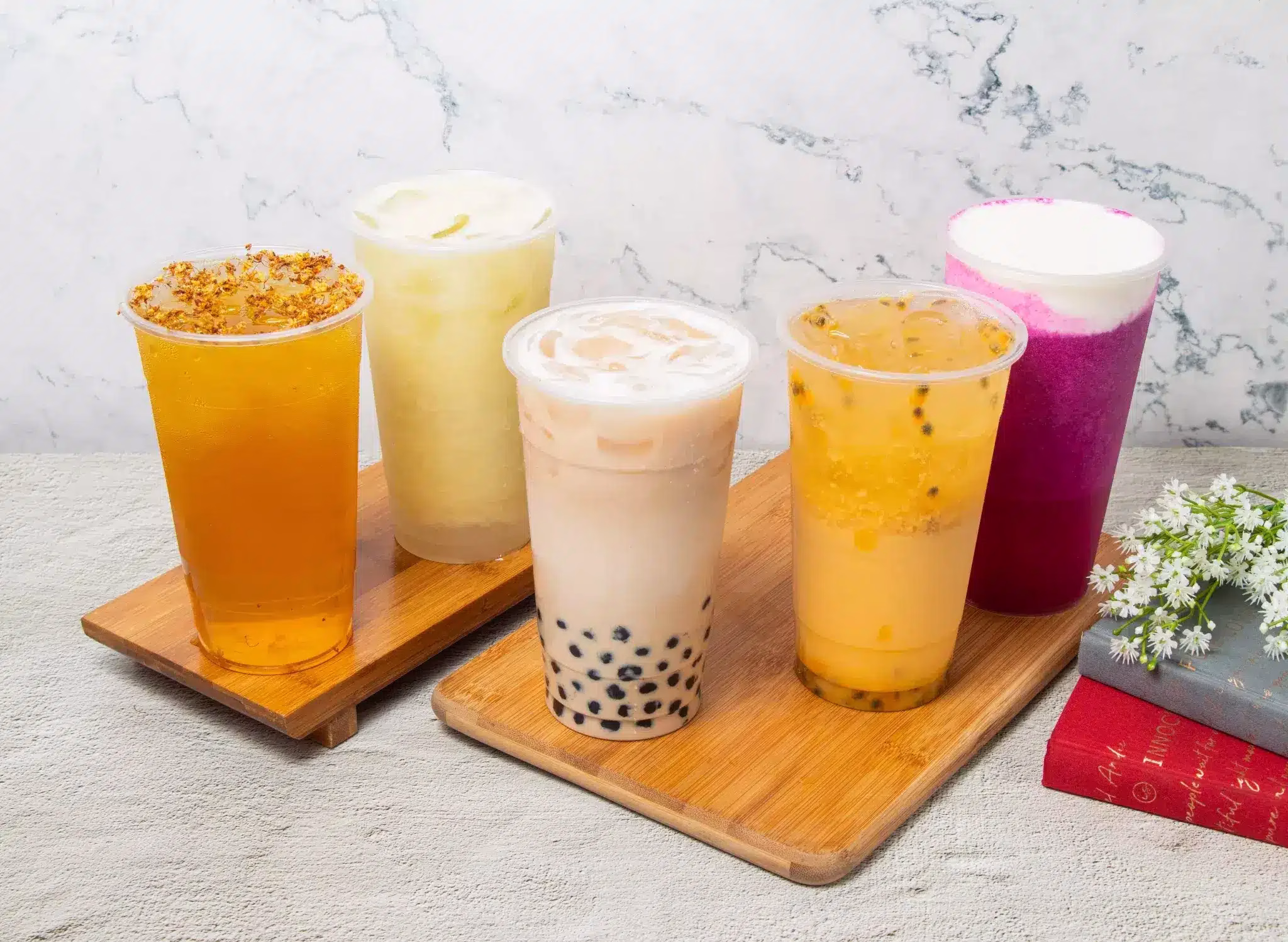 Assorted bubble tea drinks on wooden trays