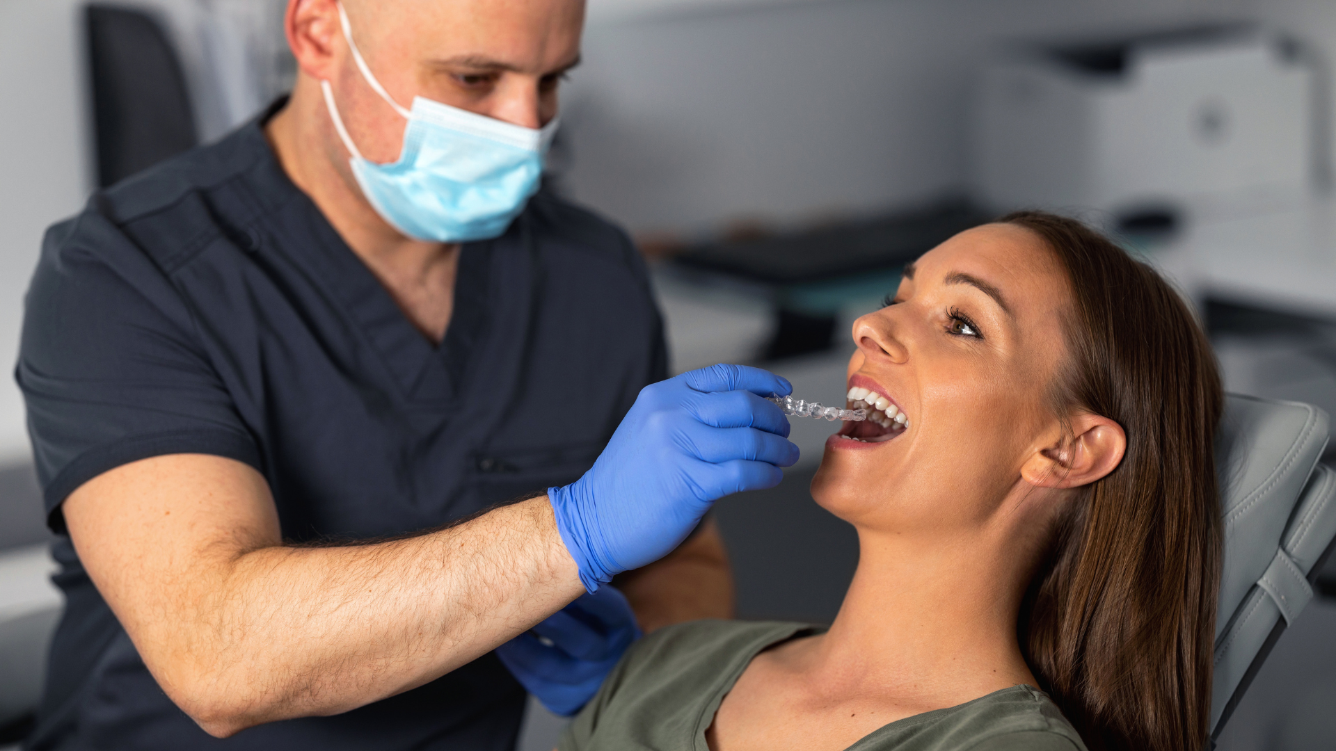 dentist inserting braces to a lady