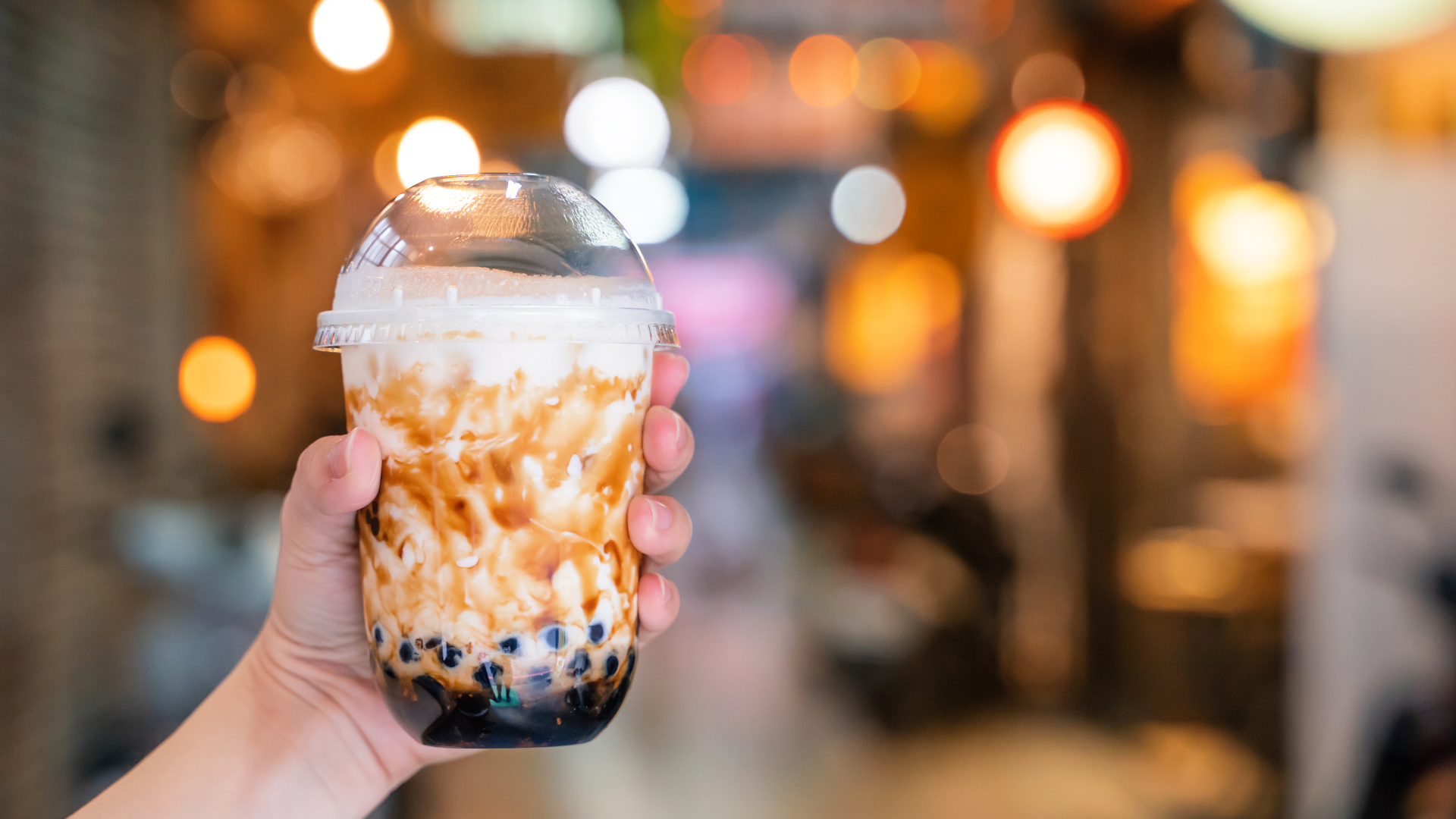 Hand holding bubble tea cup