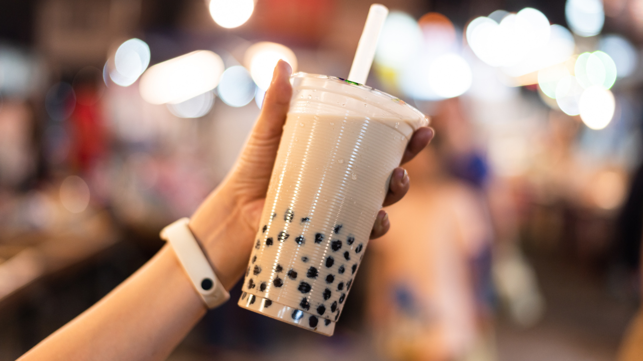 a hand holding bubble tea