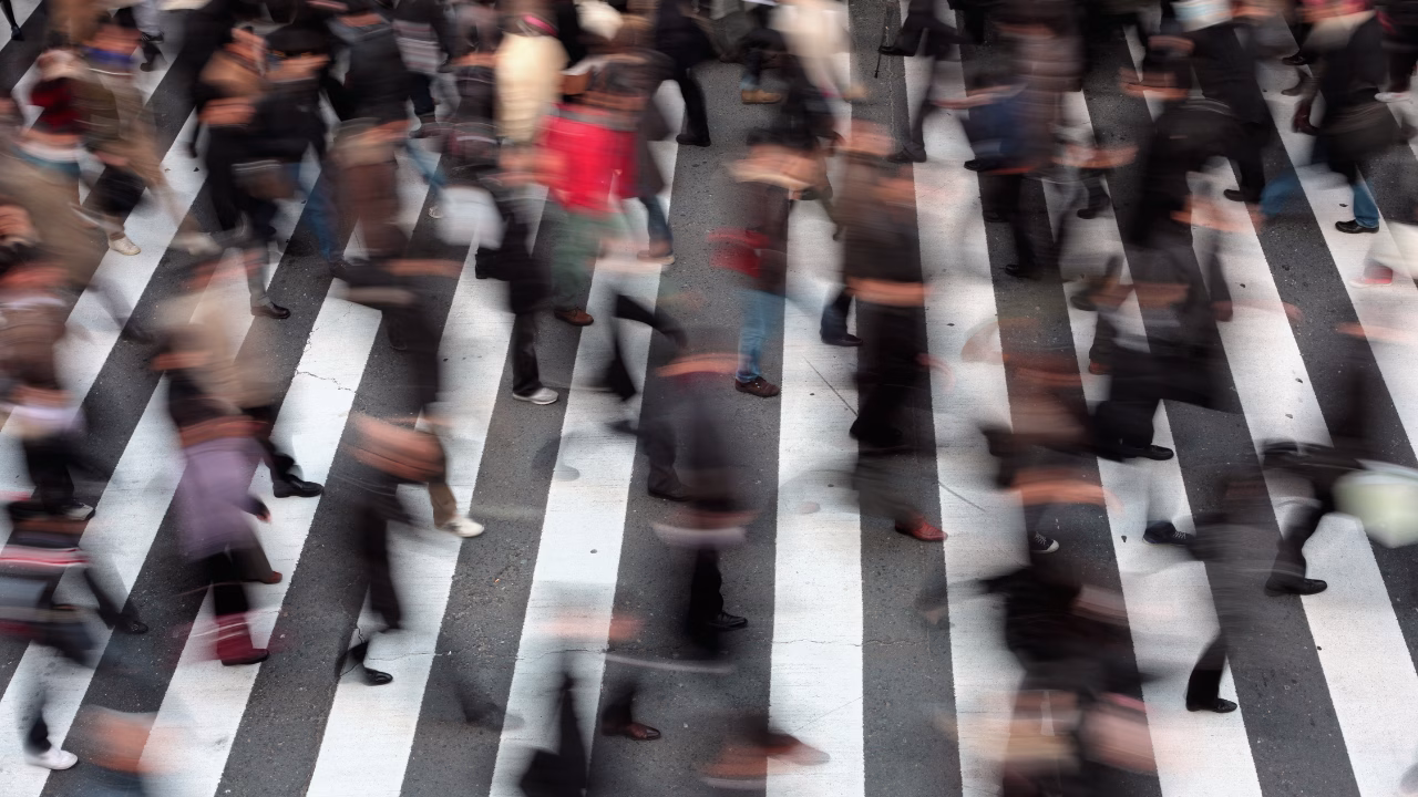 many people on pedestrian crossing during peak hours